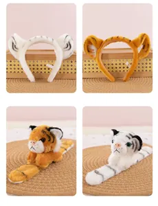 Macro view of white and orange tiger plush ear headbands with matching toy props.