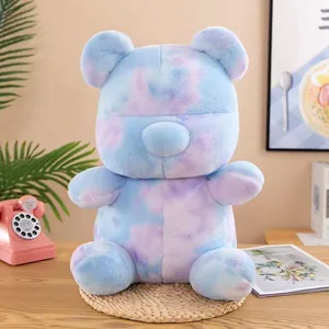 Adorable colorful tie-dye plush teddy bear toy presented in a cozy home lifestyle setting