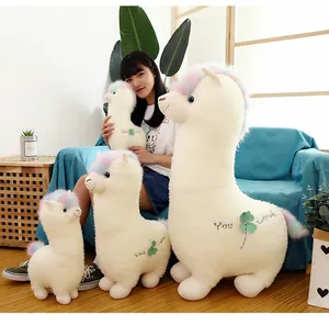 White alpaca plush toys in four sizes featuring rainbow manes and clover embroidery