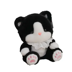 Adorable black and white tuxedo plush cat toy with white lace collar and pink paw pads