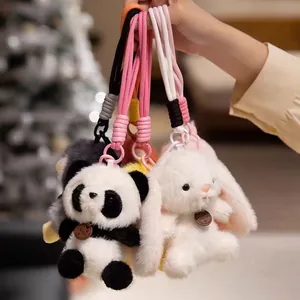 Close-up of soft plush panda and bunny keychains with woven lanyards for backpack decor
