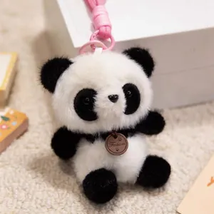 Close-up of a cute plush panda pendant with a leather fashion tag and pink strap