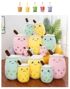 Various sizes and colors of cute boba tea cup plush toys arranged in a cozy living room