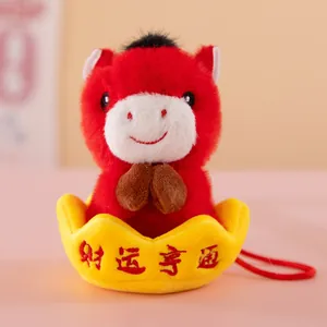 Close-up of the red Year of the Horse plush mascot keychain sitting in a gold ingot.