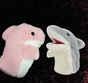 Detail view of two cute shark plush hand puppets with movable mouths in pink and grey
