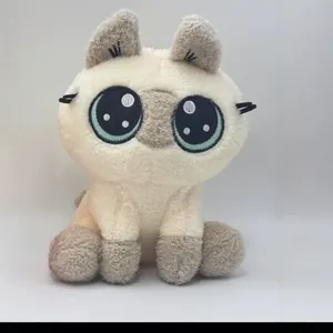 Detailed front view of a cute sitting cat plush toy featuring large embroidered eyes