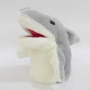Detail view of a soft plush grey and white shark hand puppet with a realistic open mouth