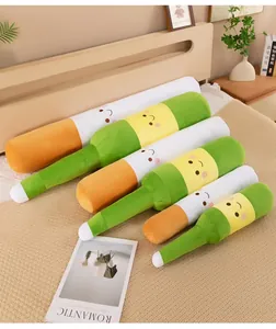 Detail view of various sizes of cigarette and beer bottle plush pillows on a bed