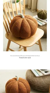 Detailed macro view of decorative bouclé pumpkin plush pillows on a wooden chair