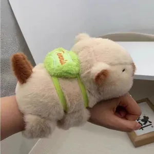 Detail showing a cute capybara plush slap bracelet with a green tennis ball backpack