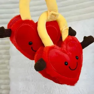 Detail view of two red heart-shaped concentric lock plush toys with cute smiley faces.