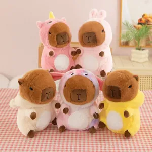 Group of cute Capybara plush toys in colorful animal costumes displayed on a table.