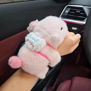 Close-up view of a cute pink capybara plush slap bracelet toy worn on a wrist in a car