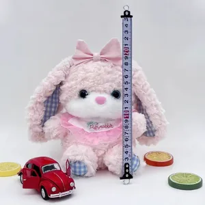Detailed view of the pink long-eared rabbit plush toy showing size measurement