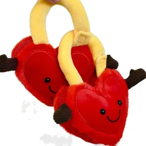 Detailed macro view of two red heart-shaped plush lock dolls with cute embroidered smiley faces.