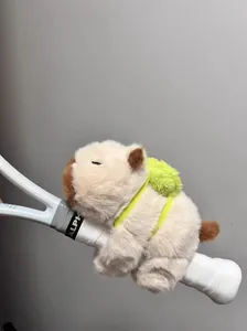 Detailed macro view of a soft plush capybara slap bracelet toy on a racket handle