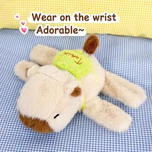 Macro view of a soft brown plush capybara slap bracelet on blue checkered fabric