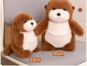 A pair of cute brown sea otter plush toys in 23cm and 30cm sizes displayed on a grey chair
