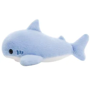 Detailed side view of a soft light blue shark plush toy in a resting lying position