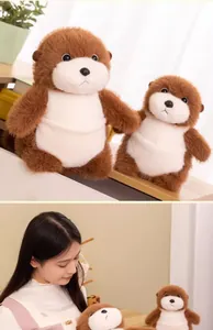 Close-up of adorable sea otter plush dolls with soft fur shown with a female model