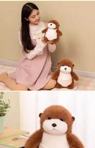Close-up detail of a soft brown sea otter plush toy showing its cute facial expression.