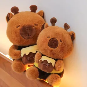Close-up of cute bee-themed capybara plush toys holding small honey pots