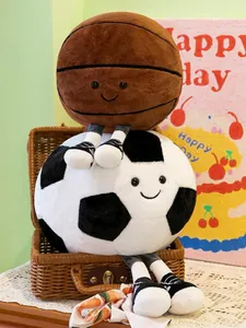 Close-up of cute soccer and basketball plush toys with smiley faces sitting in a basket