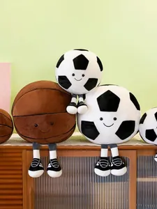 Adorable plush soccer and basketball stuffed dolls sitting on a wooden cabinet shelf