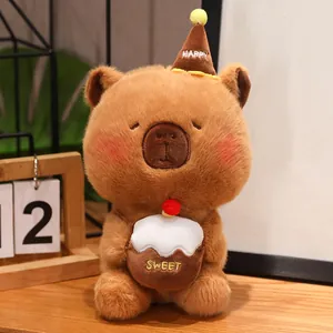 Cute brown capybara plush toy wearing a birthday hat and holding a sweet cupcake