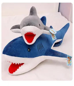 Detailed close-up of two starry sky shark plush toys in blue and grey stacked together.