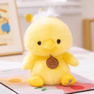 Close-up detail of a soft yellow chick plush toy featuring fuzzy texture and a decorative tag