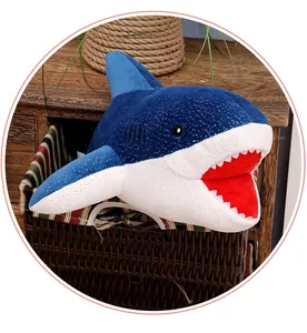 Close-up of a mini starry sky blue shark plush toy placed in a cozy woven basket
