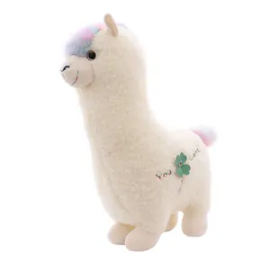 Cute white alpaca plush toy with rainbow hair and green clover embroidery detail