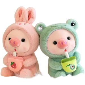 Two cute pig plushies wearing animal hoodies and holding milk tea cups on white background