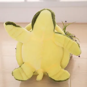 Cute green sea turtle plush toy shown from its soft yellow belly side