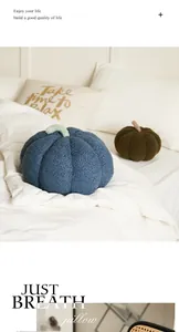 Cozy blue pumpkin-shaped plush decorative pillow displayed on a soft white bed scene