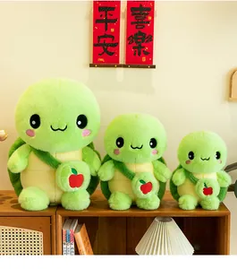 Display of three cute green turtle plush toys with small apple backpacks in various sizes