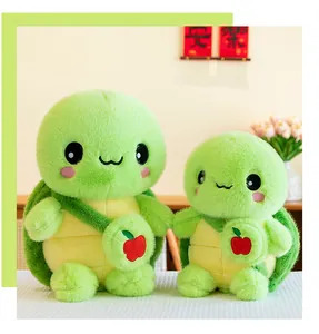 Detail view of large and small green plush turtles with cute apple bags.