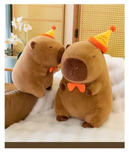 Close-up detail of soft capybara plush toy wearing a festive yellow happy birthday hat