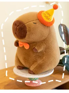 Close-up of cute Capybara plush toy wearing a yellow birthday hat and orange bowtie