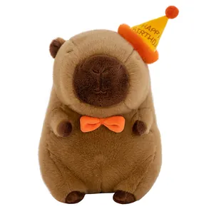 Adorable Capybara plush toy wearing a yellow birthday hat and a cute orange bowtie gift