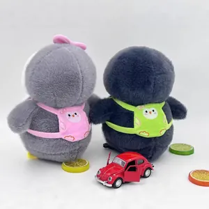 Back view of two plush penguin dolls wearing cute pink and green backpacks.