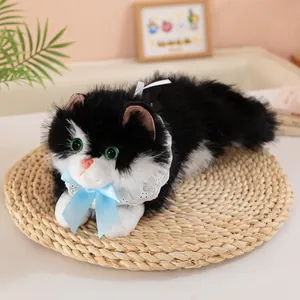 Detailed view of realistic black and white plush cat with blue bow and lace collar