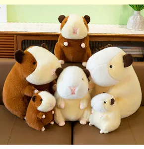 Multiple sizes of cute brown and cream guinea pig plush toys arranged on a leather sofa