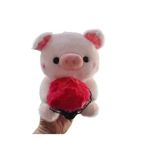 Close-up detail of a cute pink pig plush doll holding a red heart flower bouquet