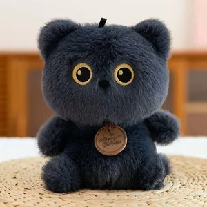 Macro detail of cute dark grey fluffy plush doll featuring embroidered golden eyes.