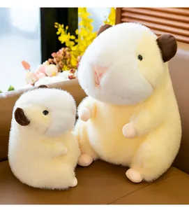 Detailed view of soft capybara plush toys in two sizes on a cozy sofa