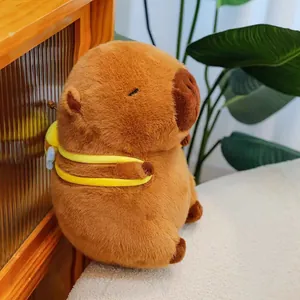 Detailed side view of a cute plush brown capybara wearing yellow bee-themed straps.