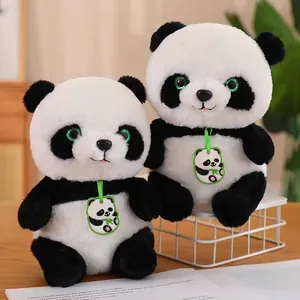 Detailed macro shot of two cute panda plush dolls featuring soft fur and green eyes