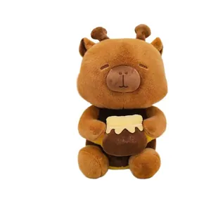 Close-up of cute capybara plush toy holding a honey pot with bee wings